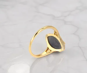 Macro detail of gold-plated S925 silver ring featuring labradorite stone setting back