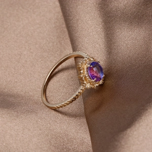 Macro shot of gold-plated silver ring featuring wheat texture and color-changing zircon stone