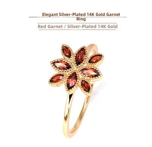 Detail of 14K gold plated flower ring featuring eight marquise cut red garnet petals