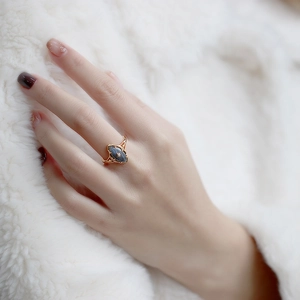 Detail of vintage gold ring featuring marquise labradorite stone and star motif