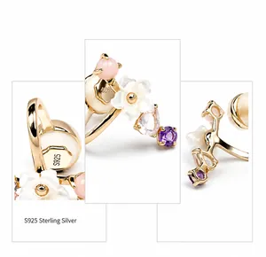 Macro detail of S925 sterling silver ear cuff with shell flower and mixed gemstones