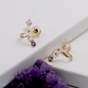 Detail of 925 silver gold-plated shell flower ear cuff with pink and purple gemstones