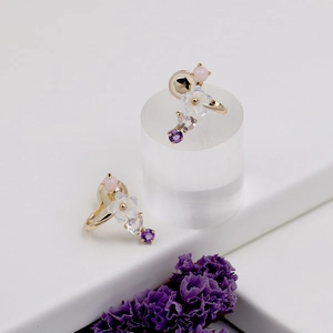 Close-up of S925 hallmark on gold plated silver earrings with shell flowers