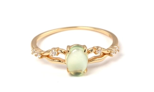 Detail of 925 silver gold-plated ring with green prehnite stone and small diamonds