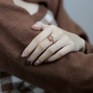 Elegant 925 silver gold-plated ring with garnet-red floral stone petals on model hand