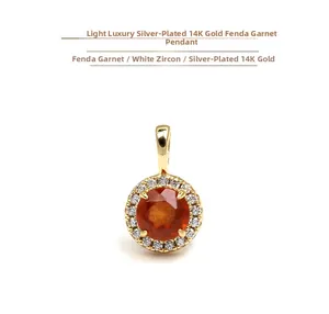 Macro shot of 14k gold plated silver pendant with orange garnet and white zircon pavé