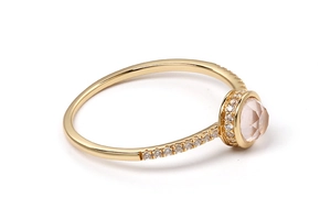 Close-up of pink quartz silver gold plated ring with micro-pave diamond accents