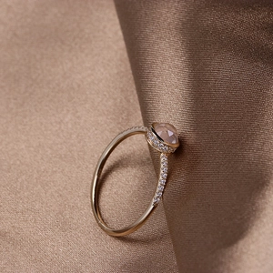 Detailed macro view of silver gold plated ring with rose cut pink crystal and pavé stones