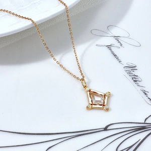 Detailed close-up of a vintage-style gold-plated silver necklace with crystal and opal