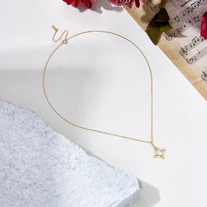 Detailed close-up of a gold-plated vintage geometric pendant featuring a clear crystal stone