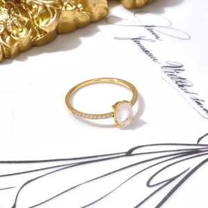 Close-up of S925 sterling silver moonstone ring with zircon accents on a vintage background