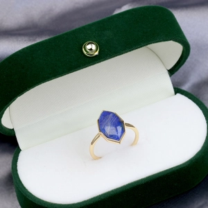 Detailed macro view of a hexagon blue lapis gemstone set in a vintage gold ring