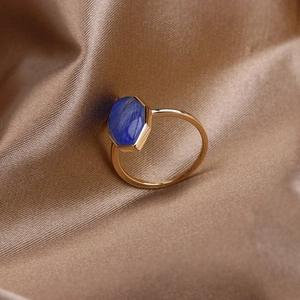 Macro top view of hexagonal blue lapis lazuli stone set on a vintage gold S925 ring band