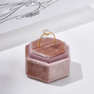 Elegant gold plated silver ring with oval moonstone and diamonds on pink velvet box