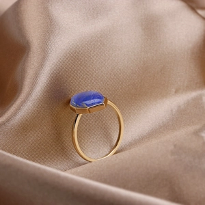 Macro detail of hexagonal blue lapis lazuli stone on a vintage gold S925 silver ring