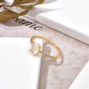Macro view of sterling silver gold plated ring with moonstone and side zircon detail