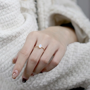 Elegant natural moonstone ring in rose gold with shimmering diamonds on a thin band
