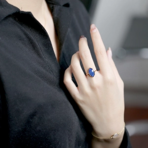 Macro view of vintage gold ring with marquise blue lapis lazuli on model hand