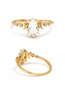 Detailed macro view of S925 sterling silver stamp and teardrop opal gemstone on gold ring