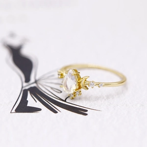 Close-up of S925 silver ring featuring pear-shaped opal and golden crescent moon detail