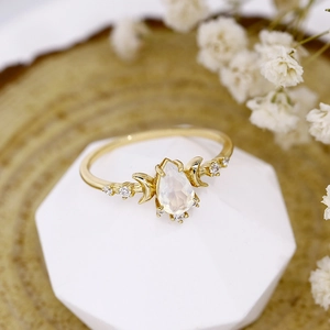 Macro shot of S925 silver gold ring with pear-shaped opal and crescent moon detail
