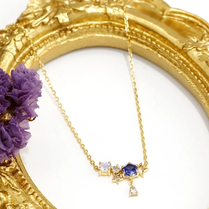 Dettaglio collana in argento S925 dorato con pietra di luna e ciondoli a stella