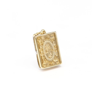 Vintage gold-plated book locket pendant with intricate baroque floral embossed pattern