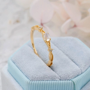 Detail of S925 silver gold plated ring with moonstone and intricate beaded engraving