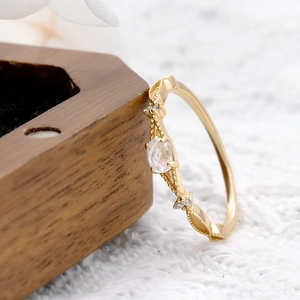 Detailed side view of moonstone gold-plated ring with milgrain vintage texture