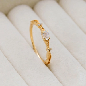 Macro view of minimalist S925 silver gold-plated ring with oval natural moonstone