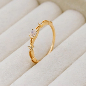 Detail showing natural moonstone in S925 silver ring with milgrain edge and side diamonds