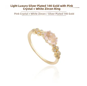 Macro detail of 14K gold plated silver ring with oval rose quartz and white zircon