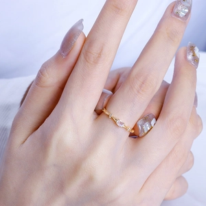 Macro shot of gold S925 silver ring featuring natural moonstone and beaded texture