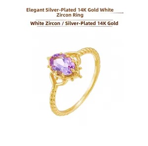 Macro shot of 14K gold plated crown ring with purple gemstone and twisted band detail