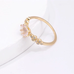 Close-up of S925 silver ring with oval pink quartz and petal-shaped zircon accents