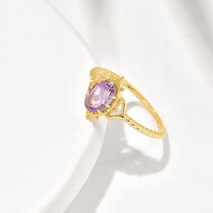 Vintage gold twisted ring with a large oval purple amethyst and crown crown lace detail