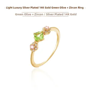 Detailed macro shot of S925 sterling silver gold ring with peridot and pink gemstones