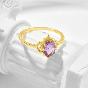 Macro shot of S925 silver vintage crown ring with purple amethyst and twisted gold band