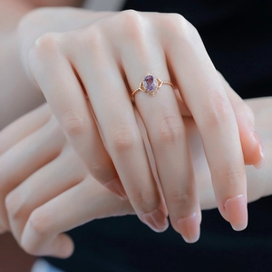 Close-up of vintage crown ring with oval amethyst and golden twisted rope band
