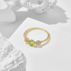 Detail of S925 sterling silver gold ring with green square gem and pink floral stones