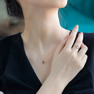 Luxurious gold necklace and crown ring set with elegant oval purple amethyst gemstones