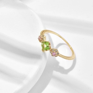 Elegant gold-plated silver ring featuring green peridot and pink flower gemstone design