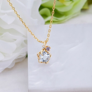Dettaglio del ciondolo a fiore in argento S925 oro 14K con topazio blu e accento viola