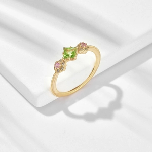 Close-up of gold plated S925 silver flower ring with green peridot and pink gemstones