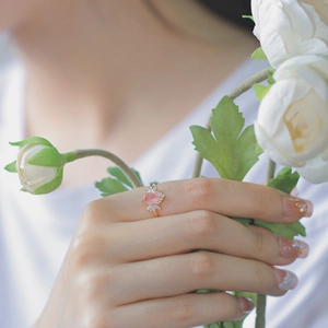 Close-up of pink strawberry quartz ring in rose gold finish with zircon accents