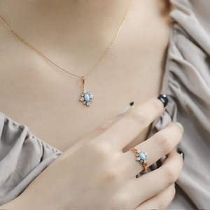 Close-up of vintage flower jewelry set featuring turquoise stones and opals on a model