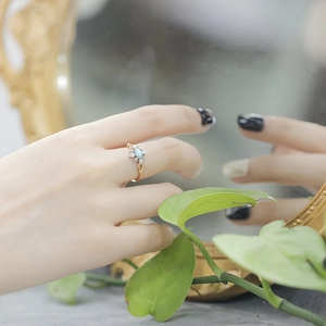 Close-up of vintage S925 silver ring with turquoise and opal stones on model's hand