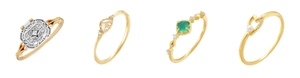 Detail von goldenen Vintage Ringen mit smaragdgrünem Stein und weißen Perlenherzen