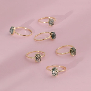 Detail of S925 silver gold-plated rings with natural moss agate in 4-prong setting