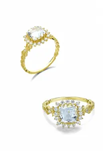 Detail macro-opname van S925 vergulde ring met vierkante topaas en geweven textuurband